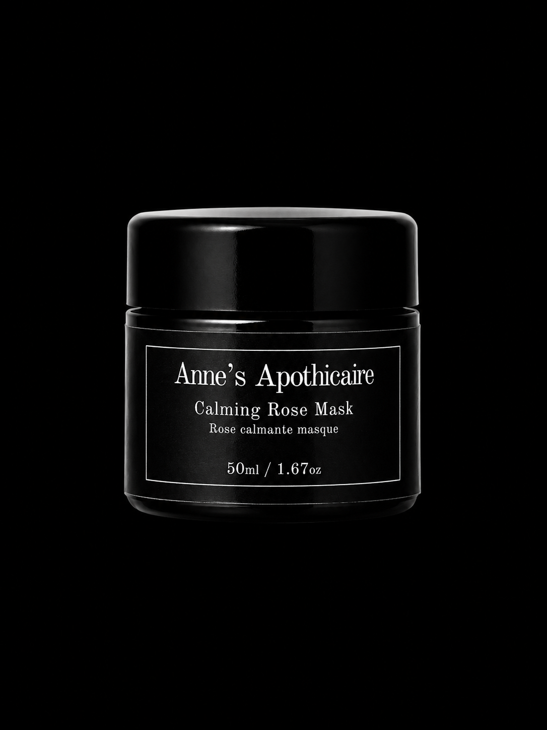 A black cosmetic jar of Anne's Apothicaire Calming Rose Mask, featuring a minimalist white label, set against a solid black background.